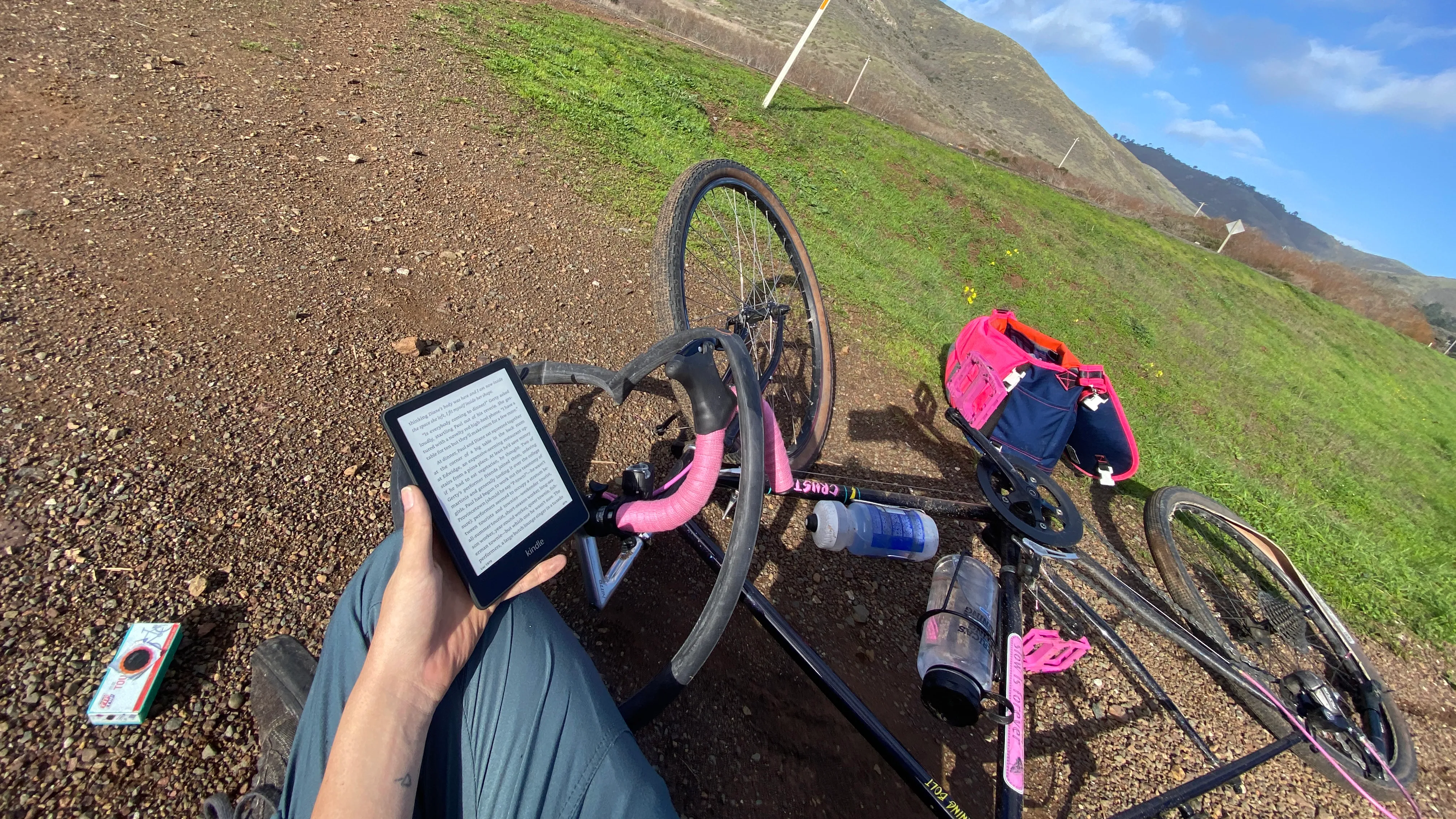 Reading on the ground while patching a flat on my bike tire