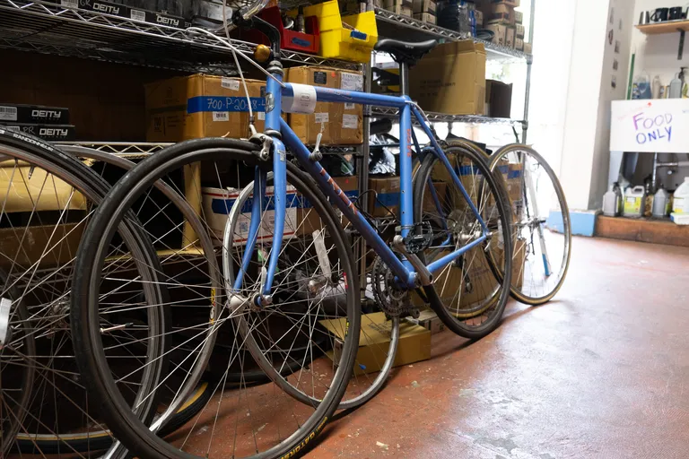 A trek 1420 bike painted blue and purple/pink in the back of Scenic Routes