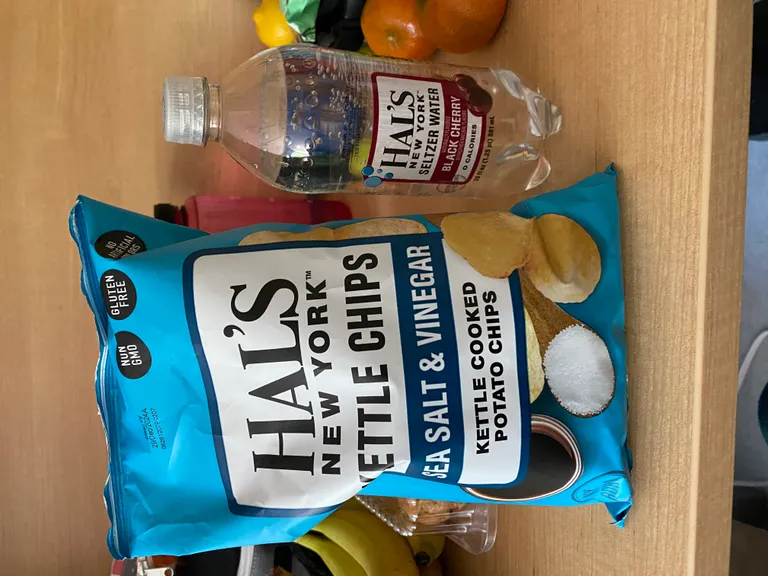 Hal's salt and vinegar chips next to Hal's black cherry seltzer water