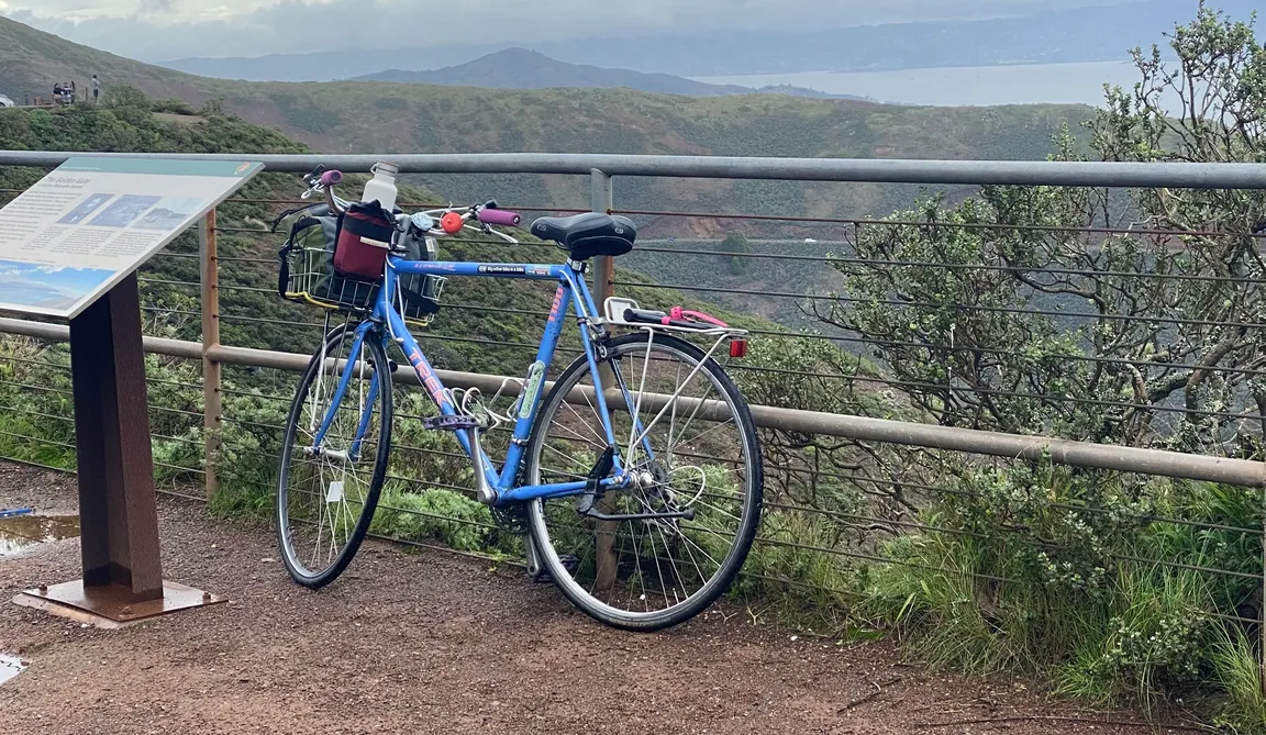 My blue Trek 1100 bike rested against a cable fence at the top of Hawk Hill in the Marin Headlands.