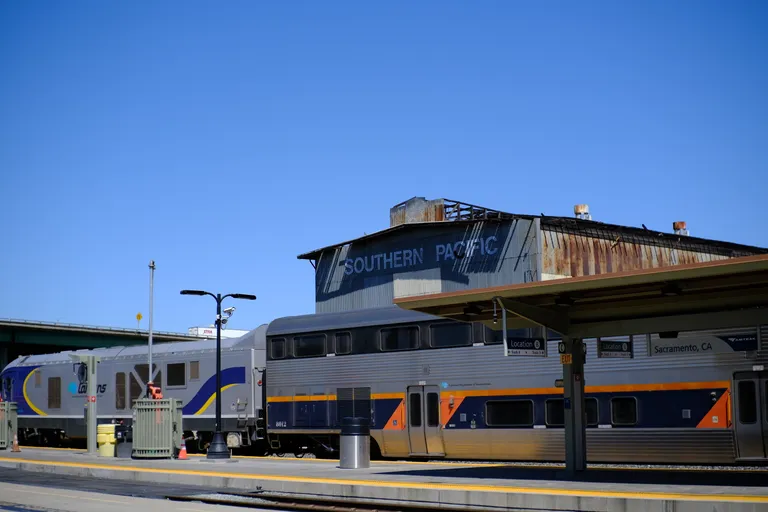 Southern Pacific sign on side of old depot building at Sacramento Valley station with a Capitol Corridor set in the foreground